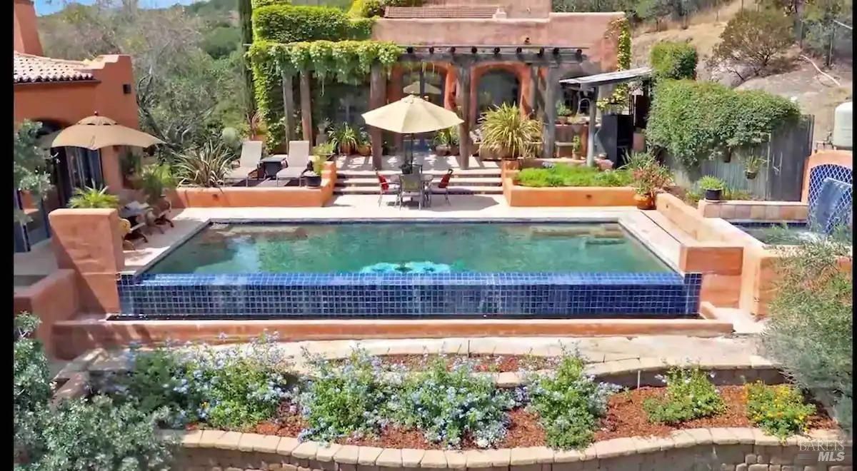 The pool area has a large rectangular pool, a fountain, and a patio with seating.