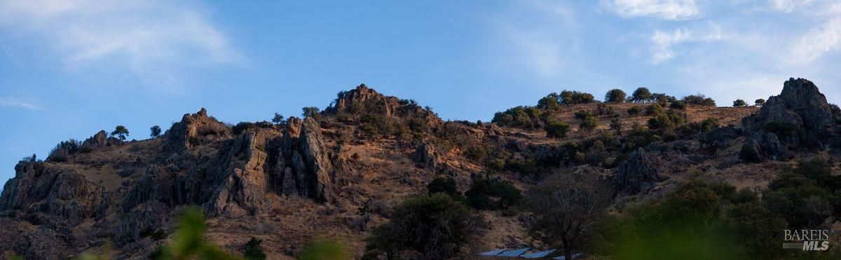 Long, rocky ridge or hill under a clear sky