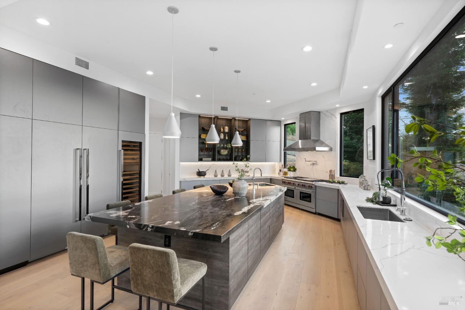 Modern kitchen with a marble island, sleek cabinetry, and high-end appliances.