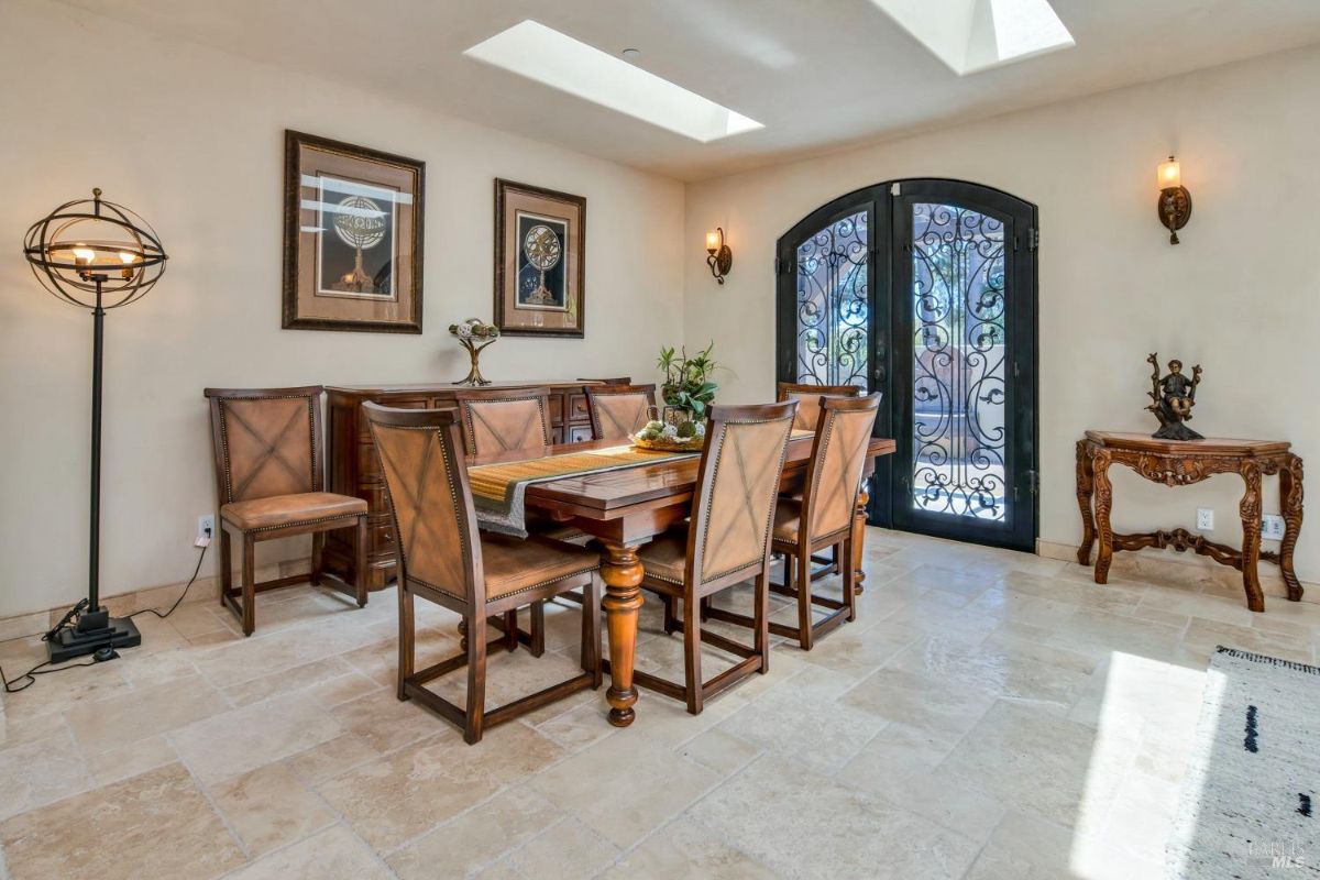 Dining room with a large rectangular table and six chairs.