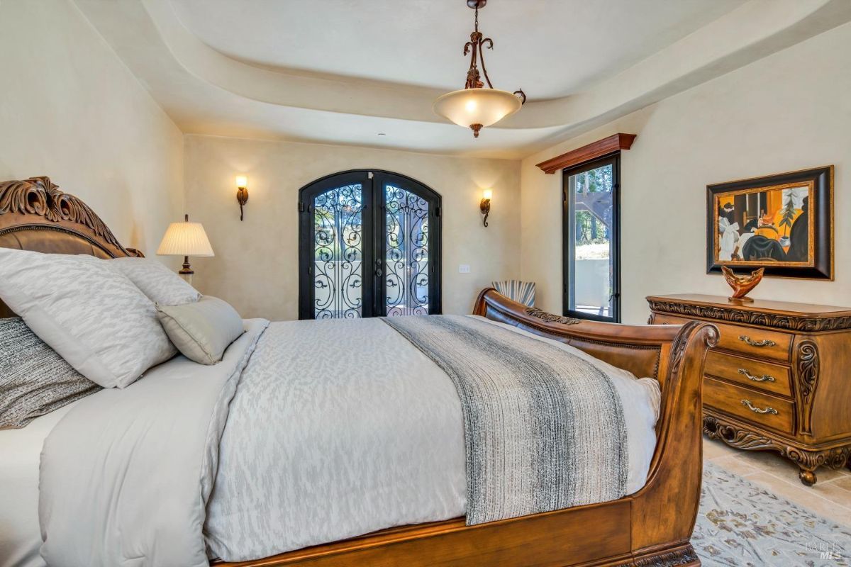 The bedroom features a king-sized bed with a wooden headboard and a dresser.