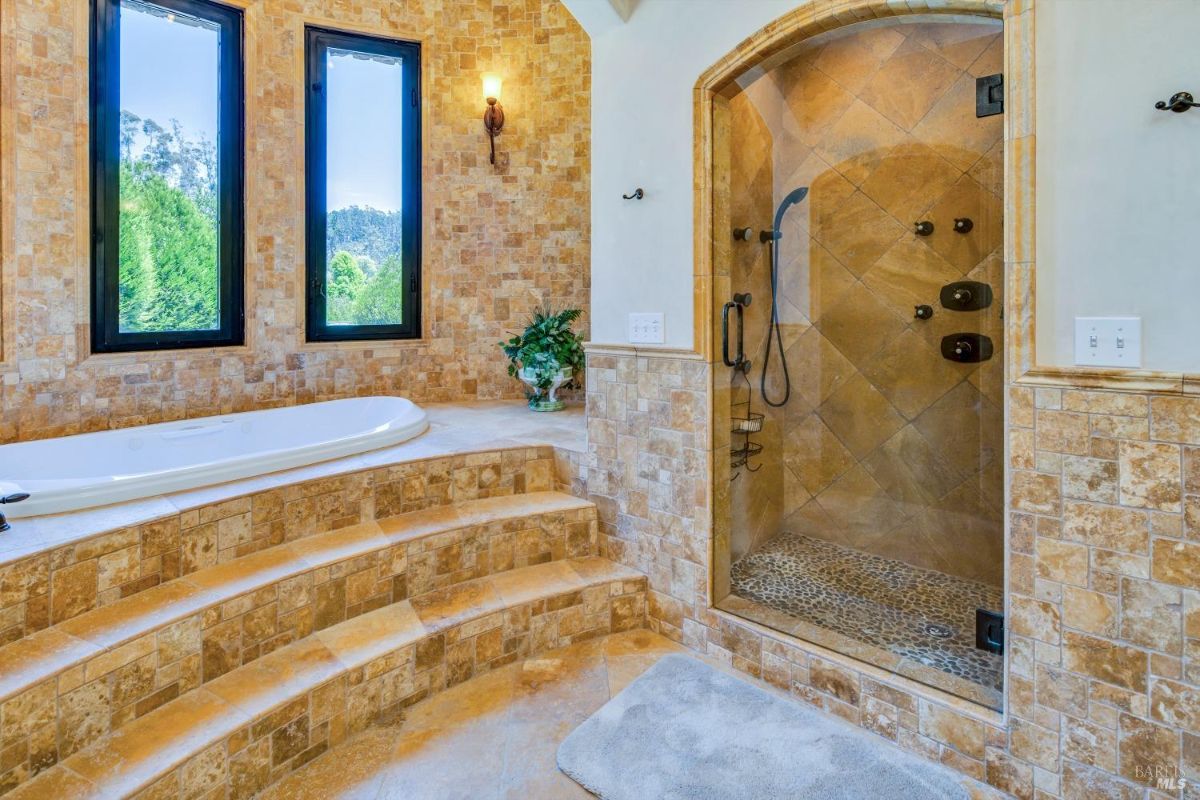 The bathroom features a bathtub, a walk-in shower, and a tiled floor.