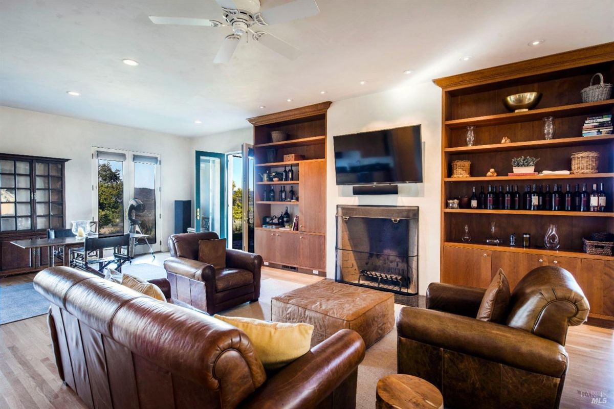 Alternative angle of the family room highlights entertainment area with a TV and door leading to the patio.