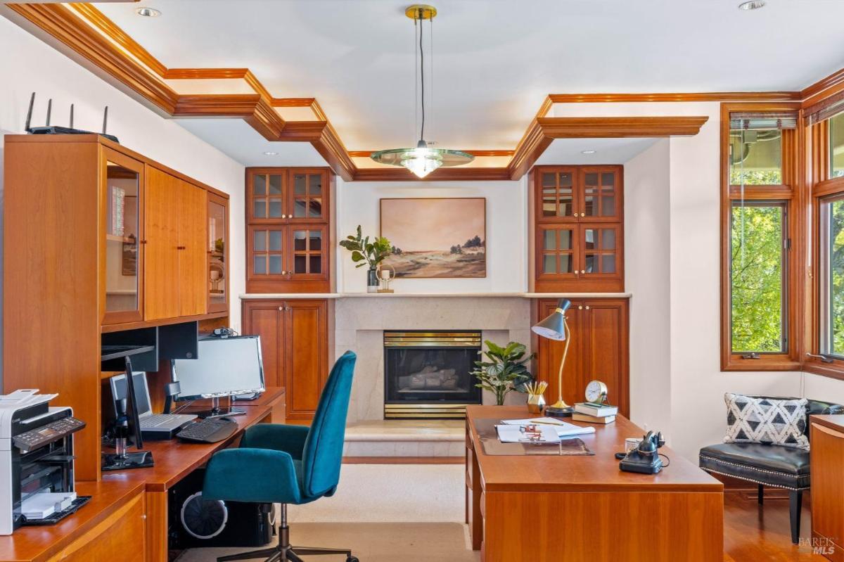 Home office with a desk, computer setup, and built-in shelves.