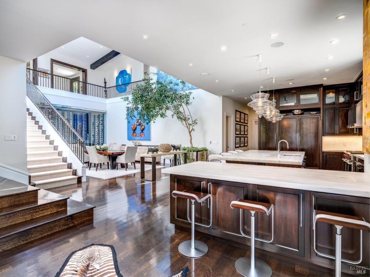 Kitchen and dining area with a staircase leading to the upper floor.