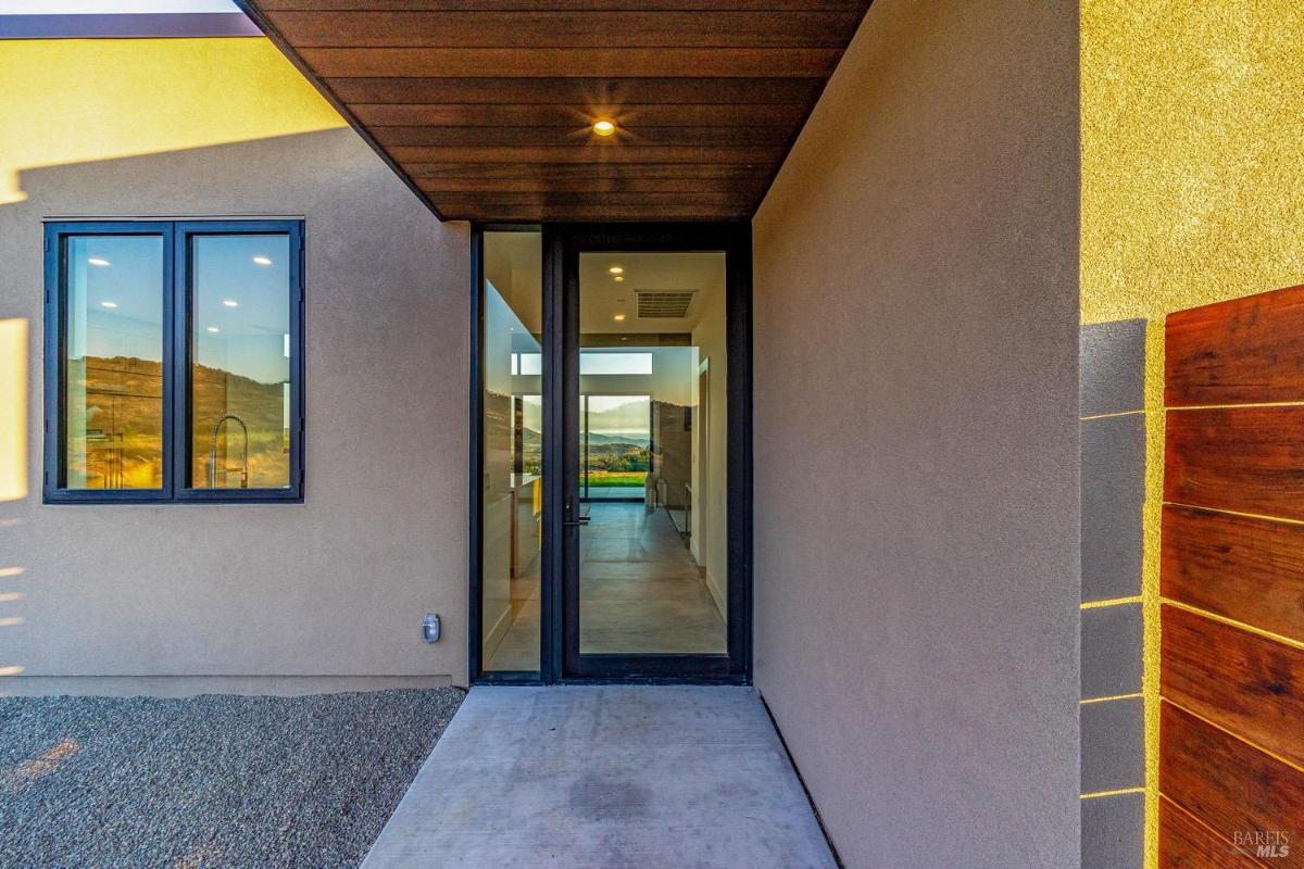 A close-up of the entrance featuring a glass door and a small window.