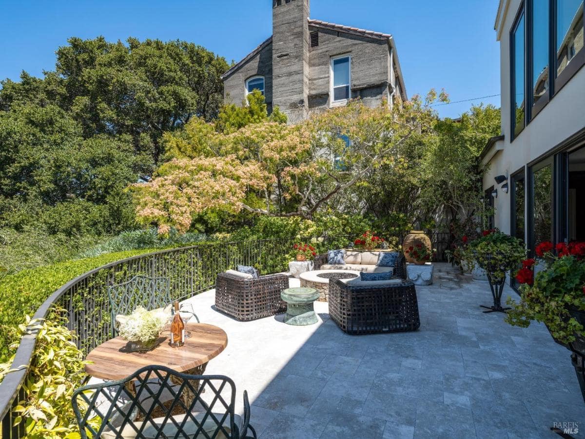 Another outdoor seating area with patio furniture and trees.