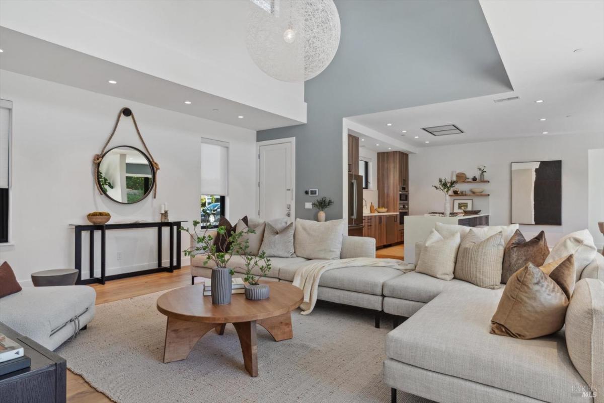 Living area with a large sectional and access to the open kitchen.