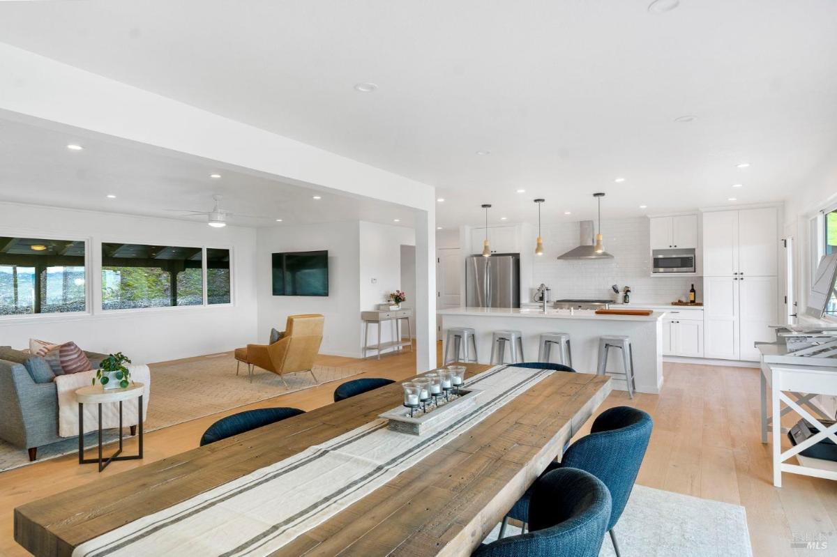 Open-concept living and dining space with kitchen in view.