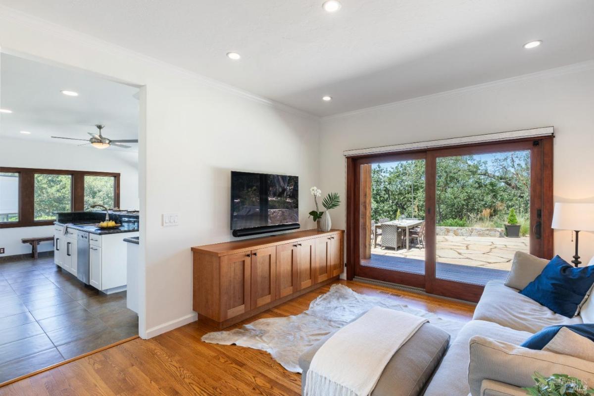 A cozy family room with a TV and sliding doors to the patio.