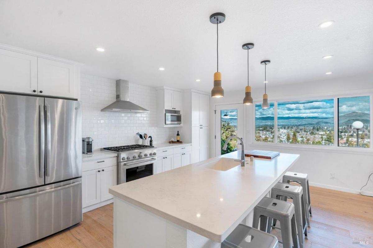 Modern kitchen with an island and stainless steel appliances.