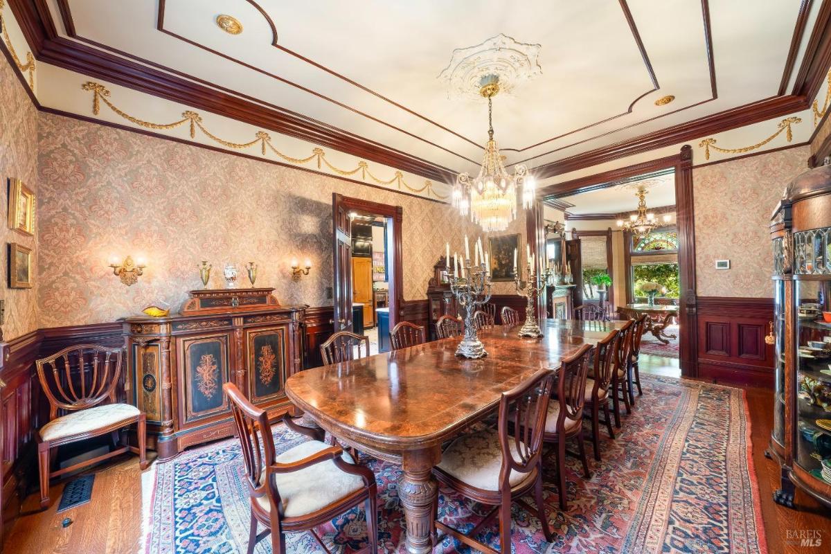 Another angle of the dining room showing intricate furniture and ceiling details.