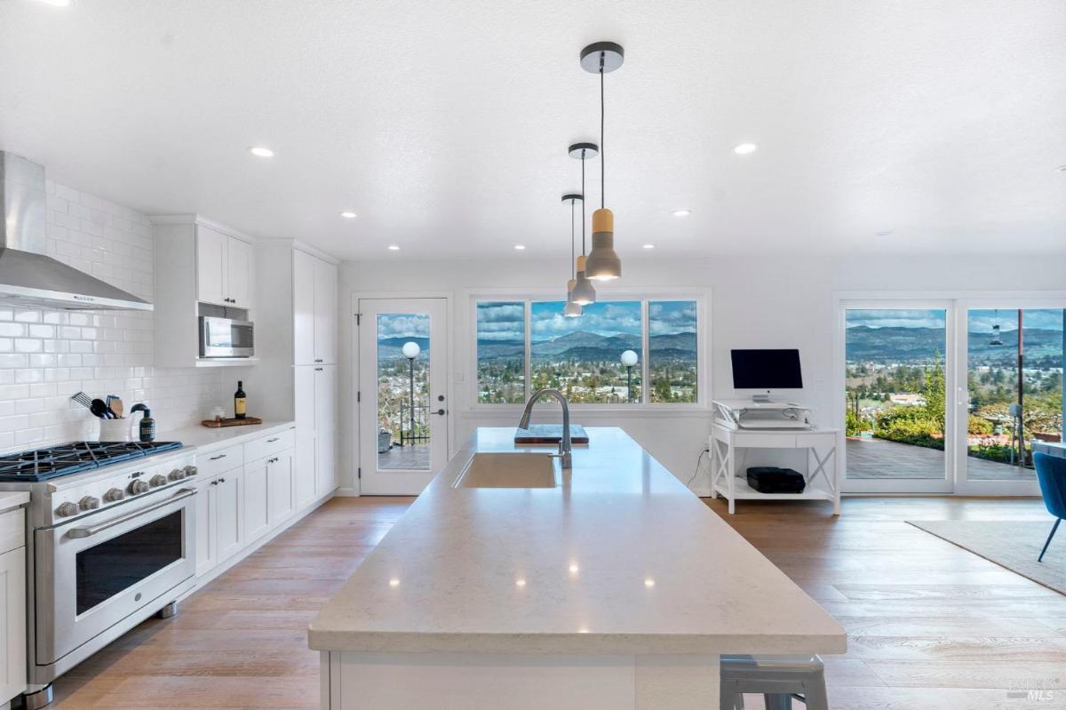 Kitchen island with pendant lighting and outdoor views.