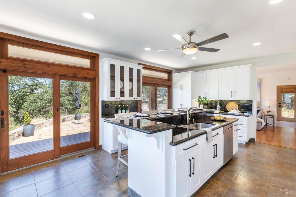 A kitchen with sliding doors leading to a patio area.