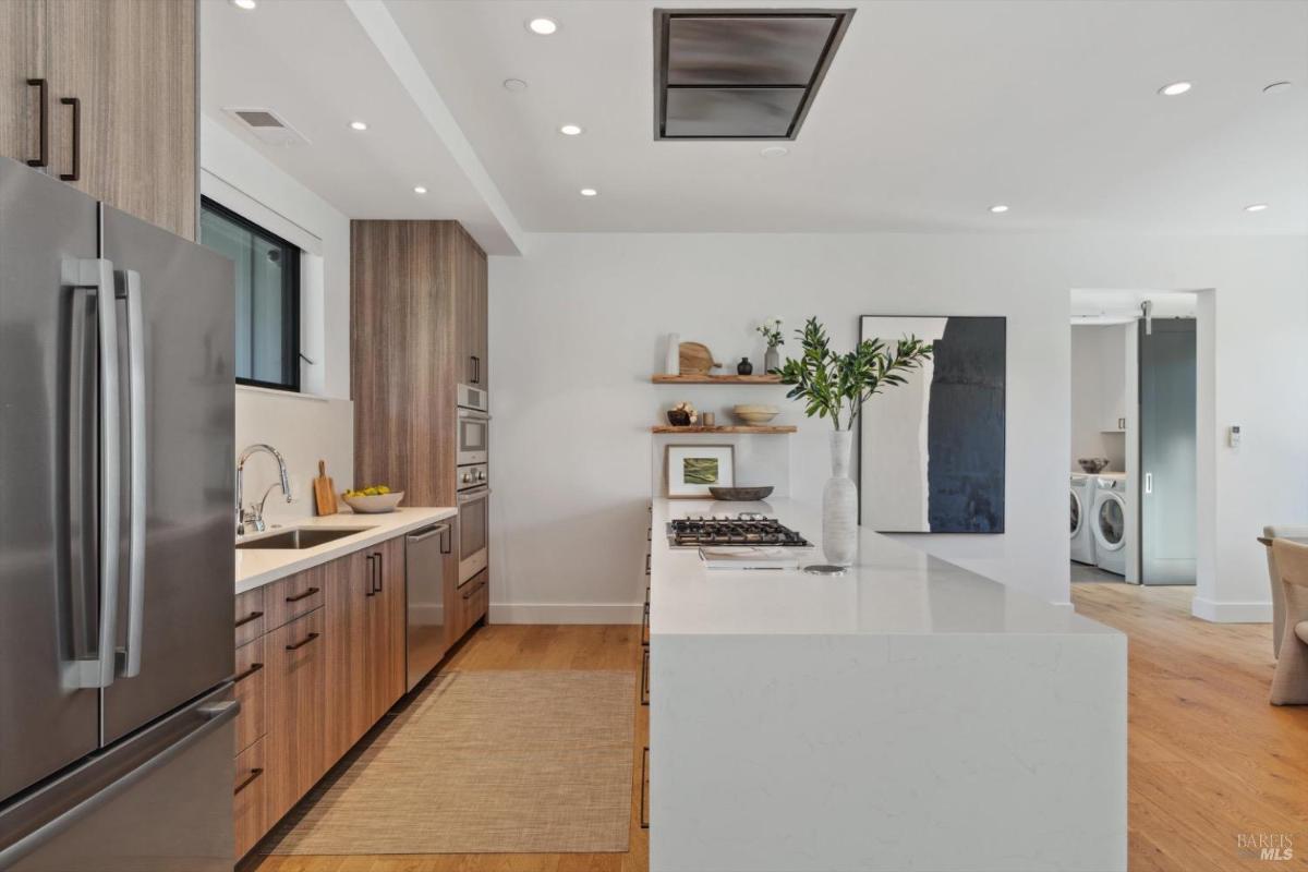 Kitchen with a view of stainless steel appliances, sink, and center island.