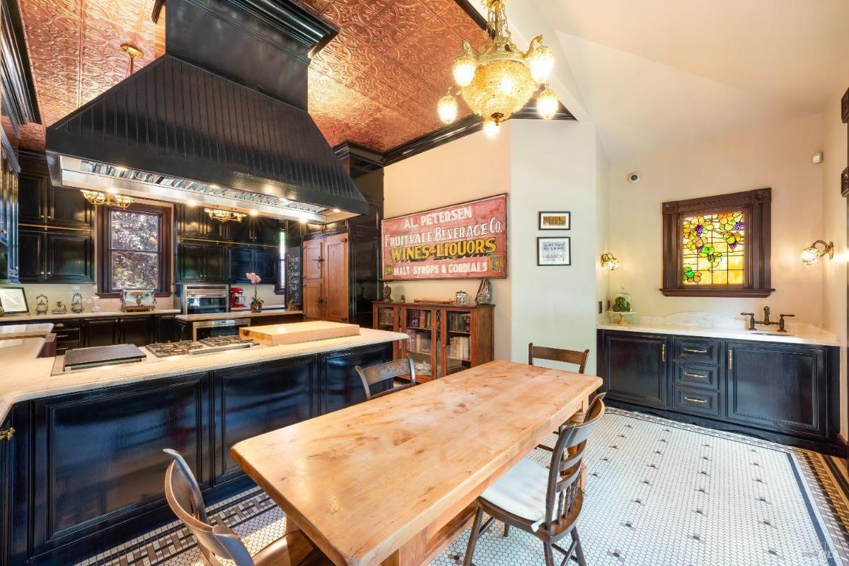 Bar area with wooden table and and stained glass window.