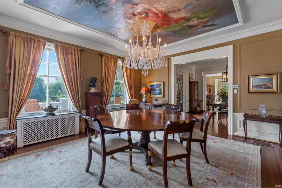 Dining room showcasing a large wooden dining table and upholstered chairs. 