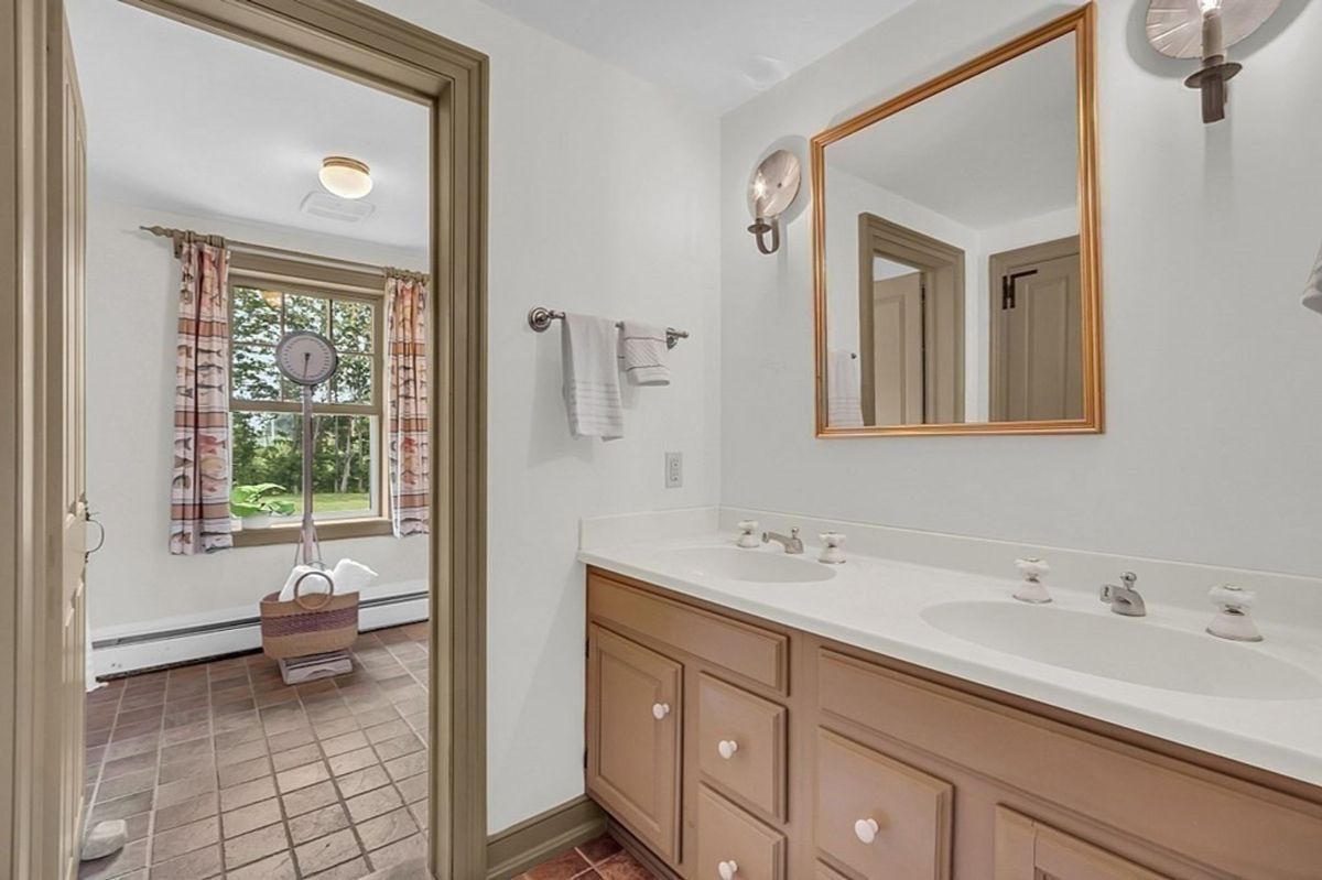 Dual-sink bathroom with natural light and a neutral design.