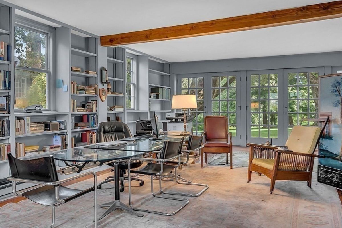 Home office with built-in bookshelves and garden views.