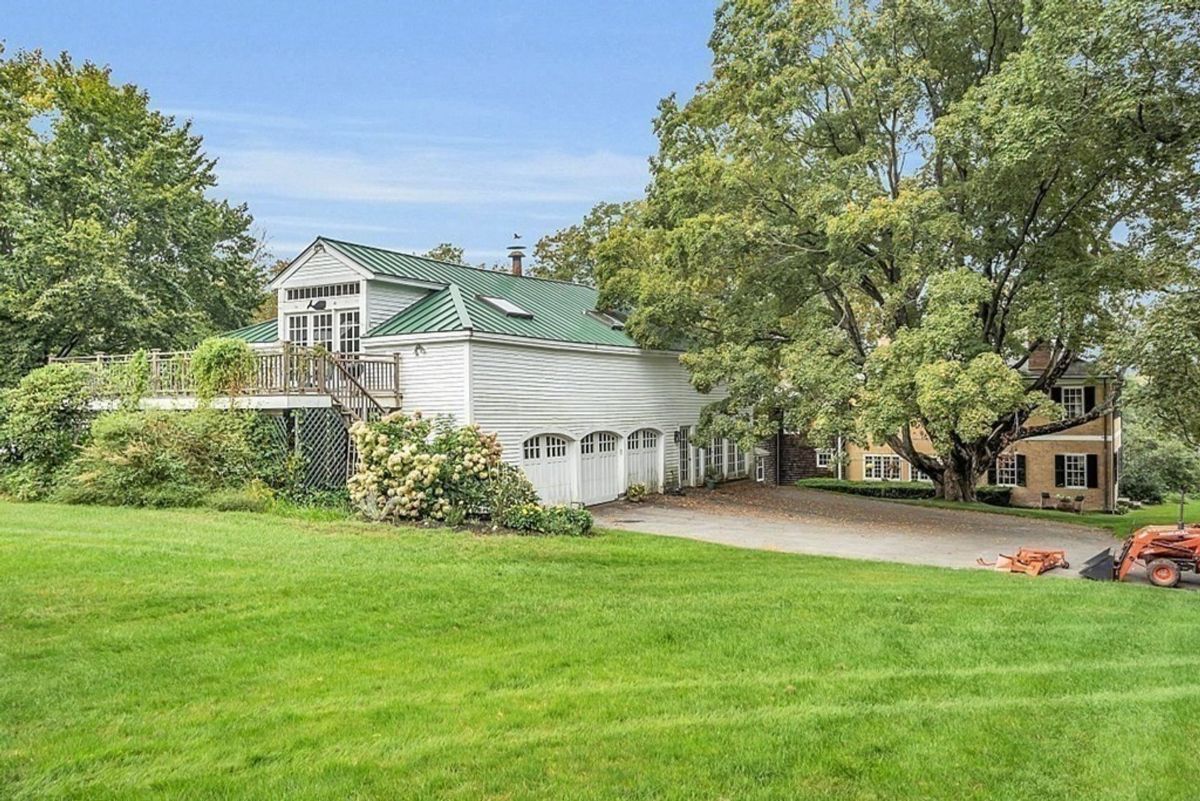 Detached building with a large deck and multiple garage spaces.