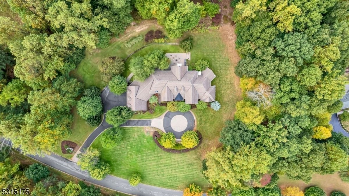 An expansive aerial view highlights the estate's beautifully manicured grounds and secluded setting.