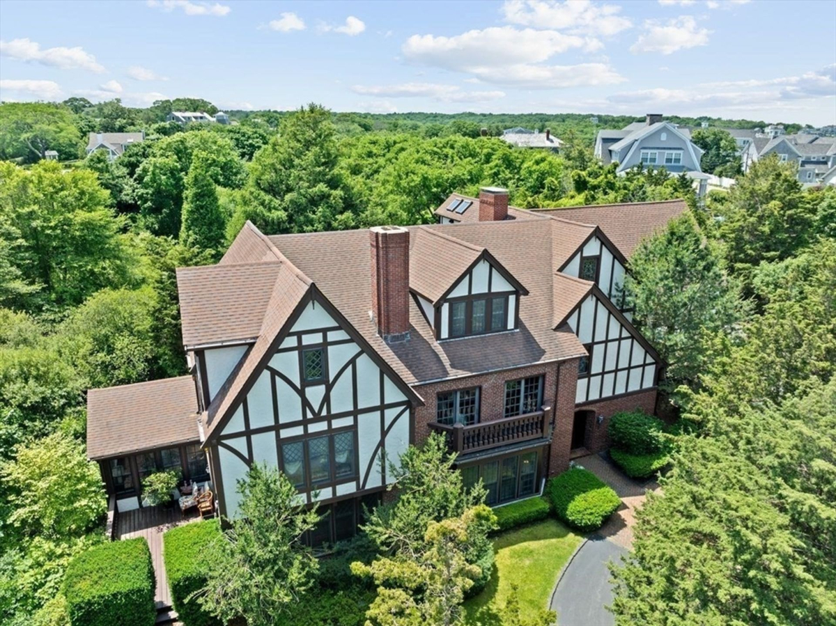 A Tudor-style estate surrounded by lush greenery, offering privacy and timeless architectural charm.