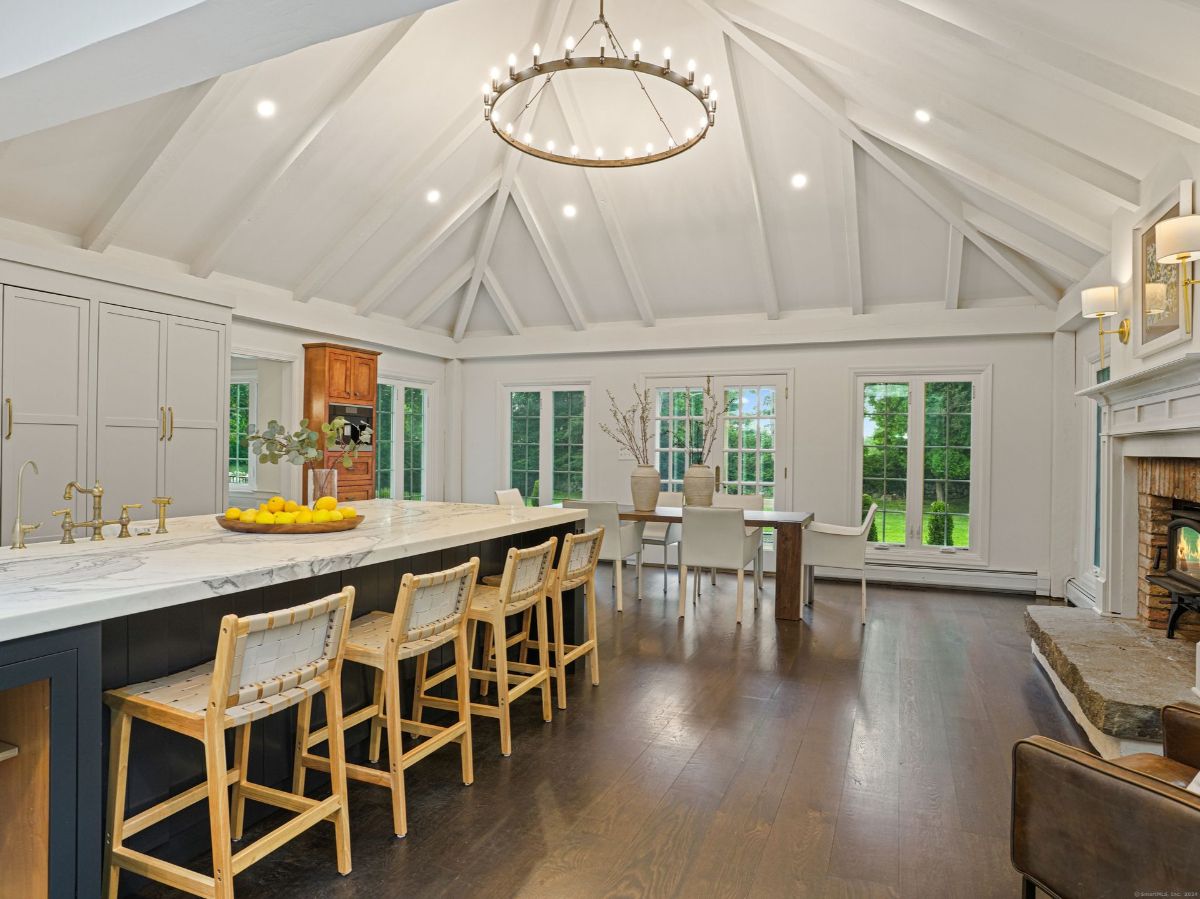 Modern kitchen with vaulted ceilings, a large center island, and built-in cabinetry.