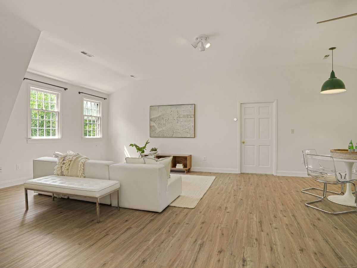 Open-concept living area with wood flooring, cozy seating, and a casual dining nook.