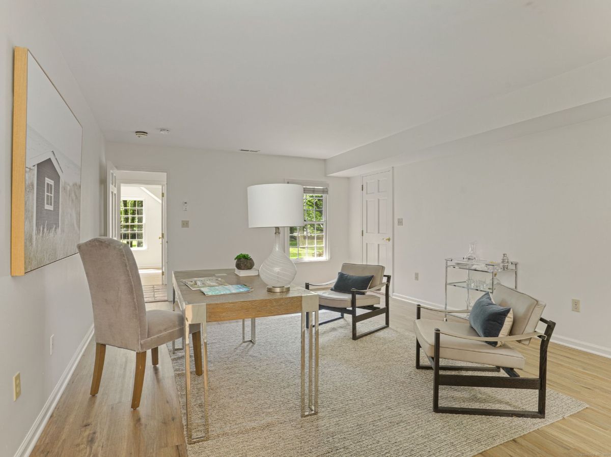 Stylish home office with sleek furniture, natural light, and a cozy rug.