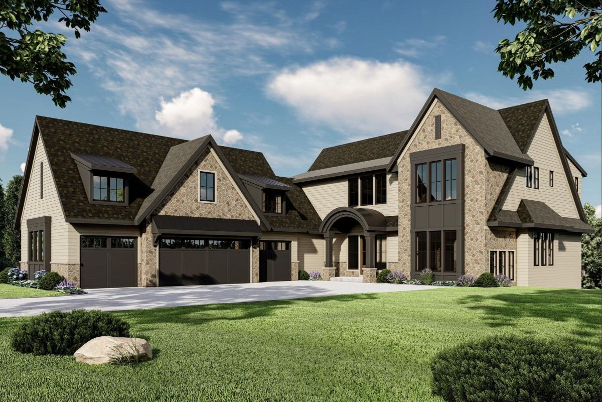 The elegant design showcases a blend of stone and siding, complemented by a modern three-car garage and an inviting arched entryway.