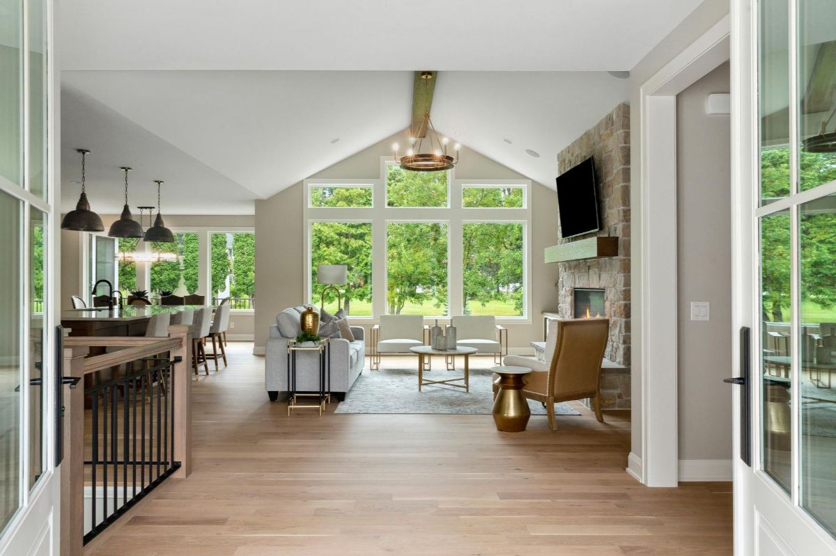 Vaulted ceilings and large windows brighten the open living space with lush green views.