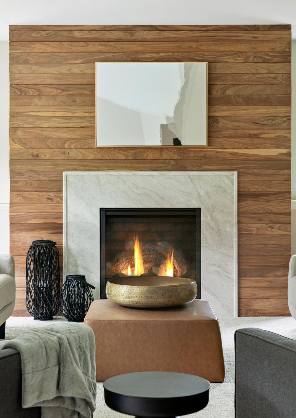 A close-up of the gas fireplace showcases its elegant marble surround and warm wood paneling, creating a sophisticated focal point.