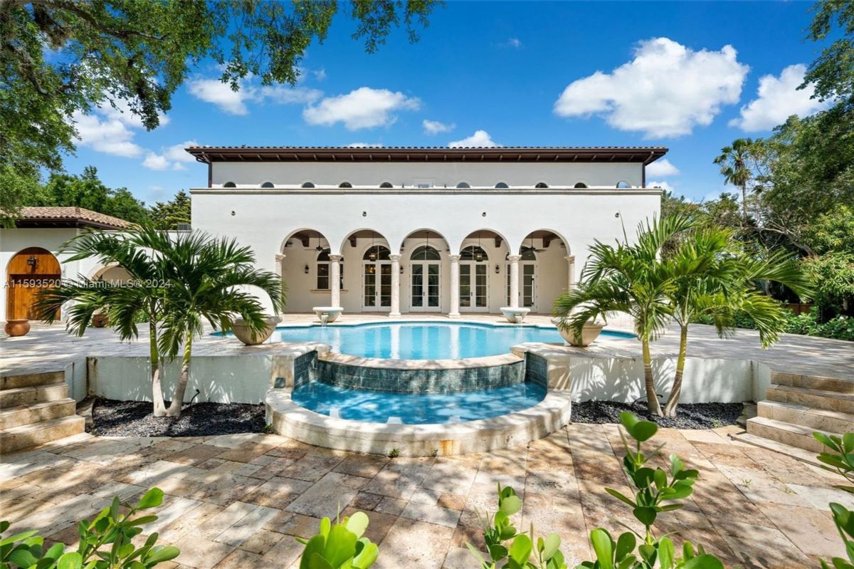 Lush green lawn surrounds the elegant white 