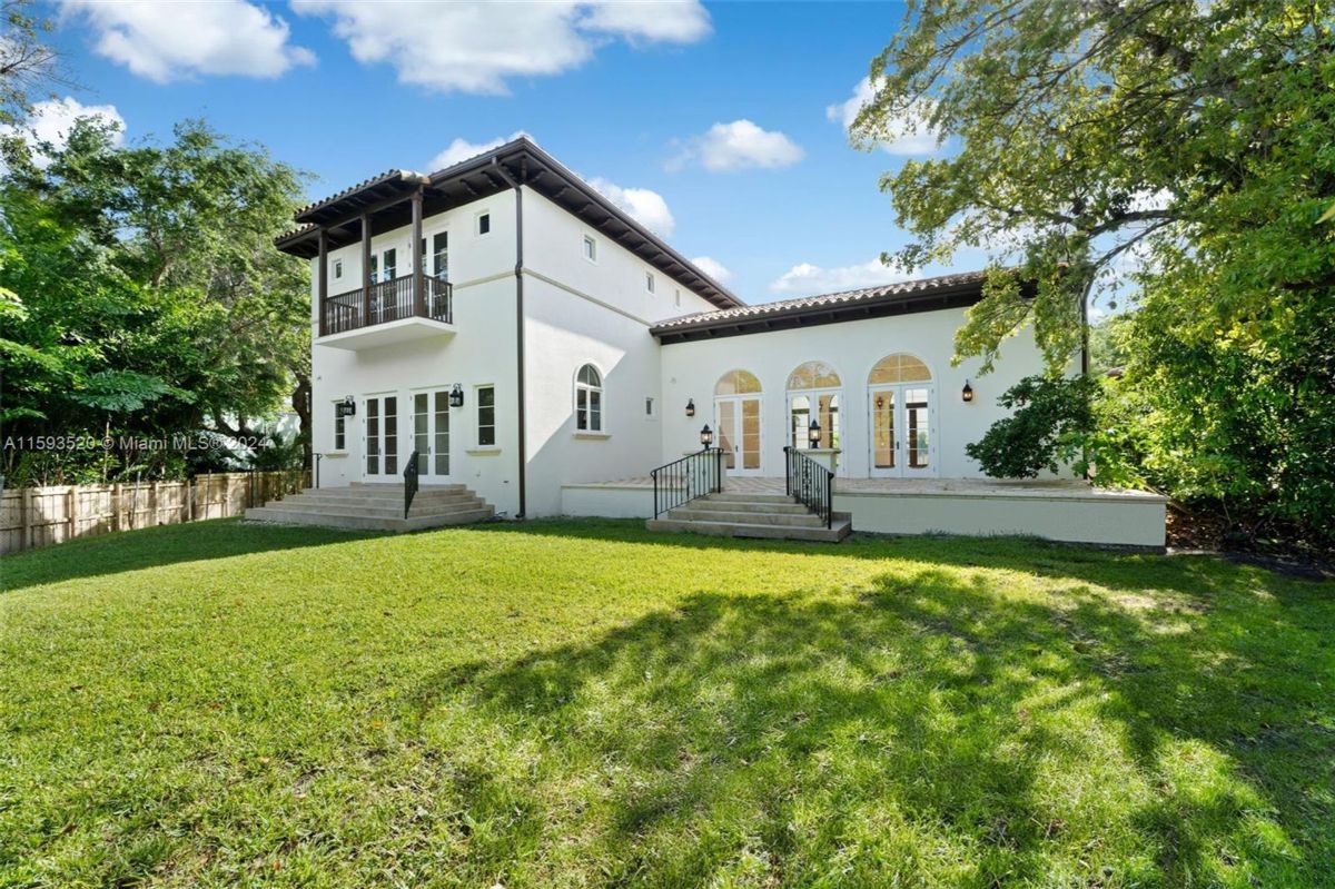 Balcony overlooking a lush green lawn.