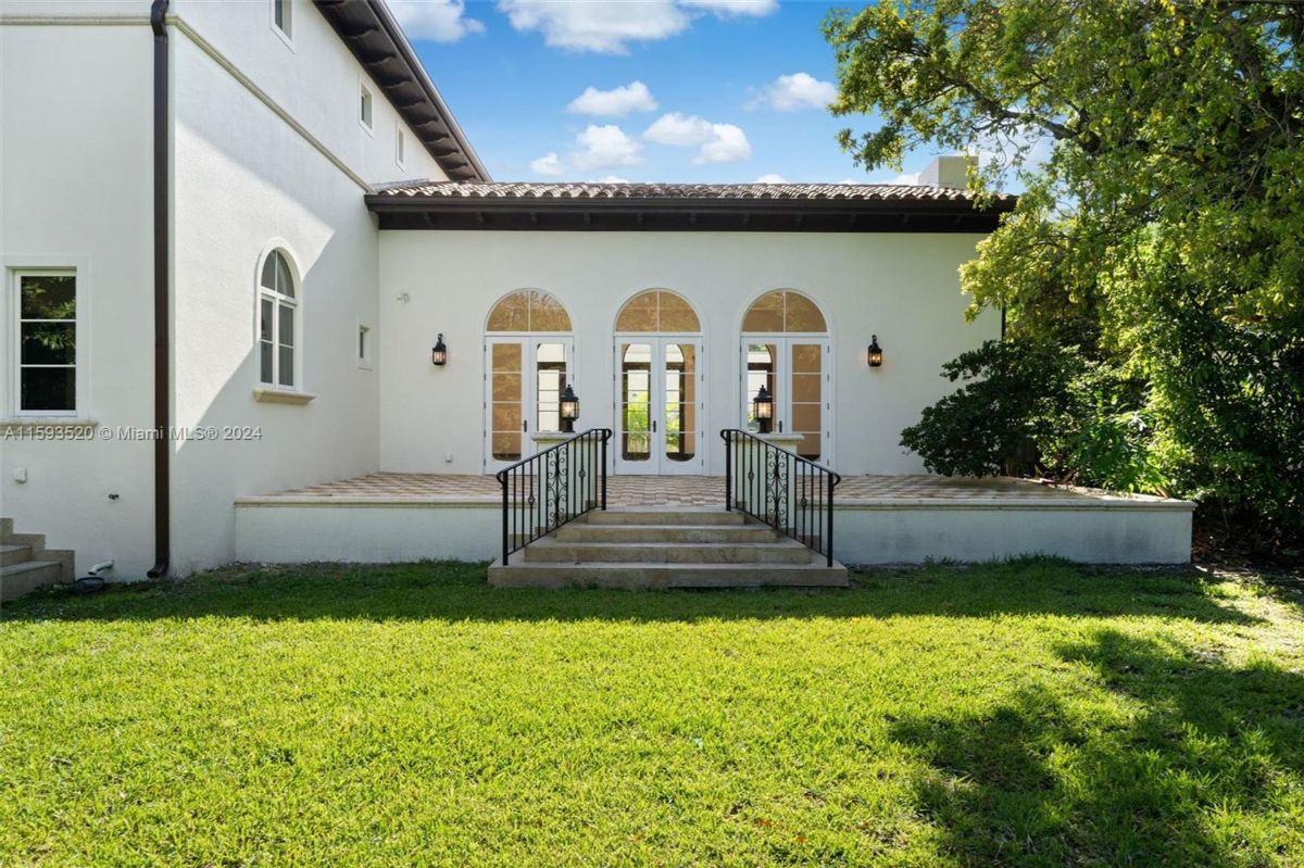 Back entrance steps lead to a bright, elegant patio.