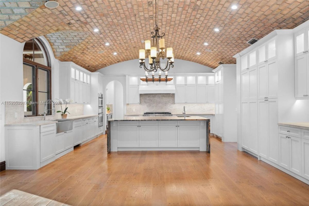 Expansive kitchen featuring a barrel-vaulted brick ceiling