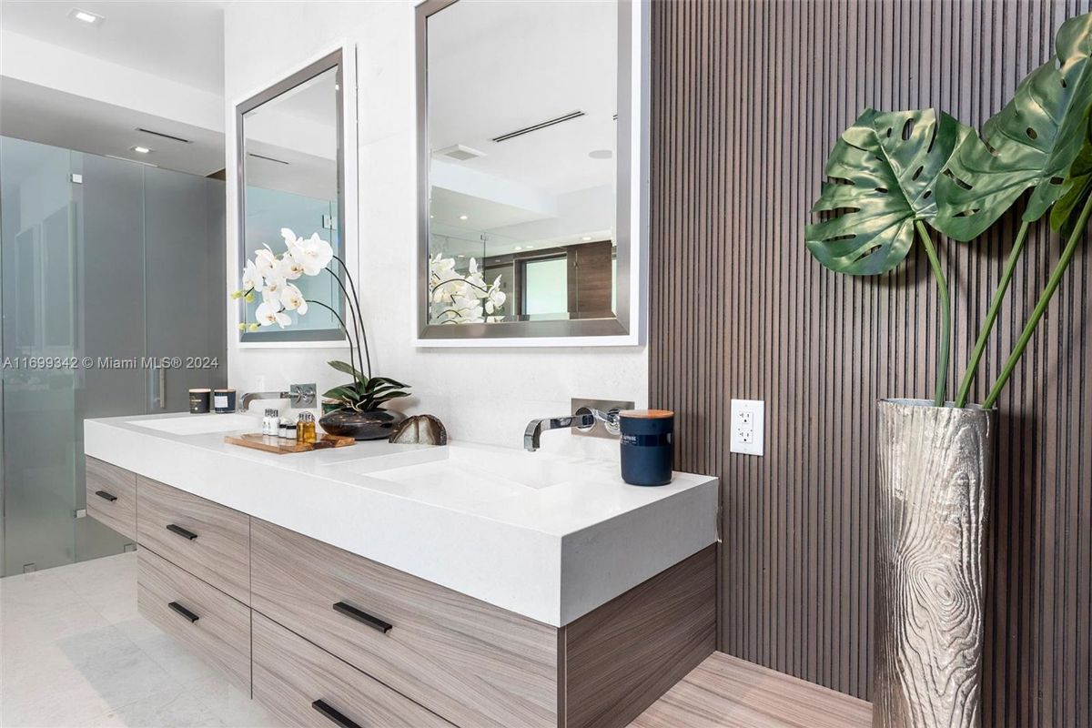 Modern double vanity with sleek design, wall-mounted faucets, and chic decor.