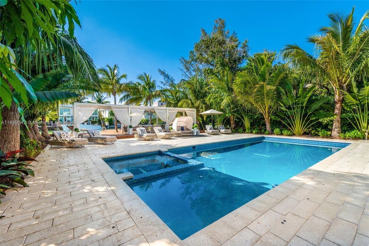 Poolside retreat surrounded by lush tropical landscaping.