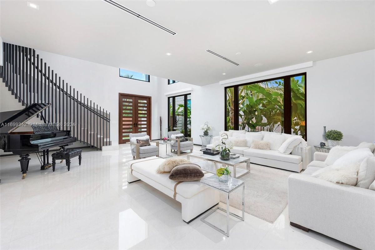 Living room with double-height ceilings, and grand piano