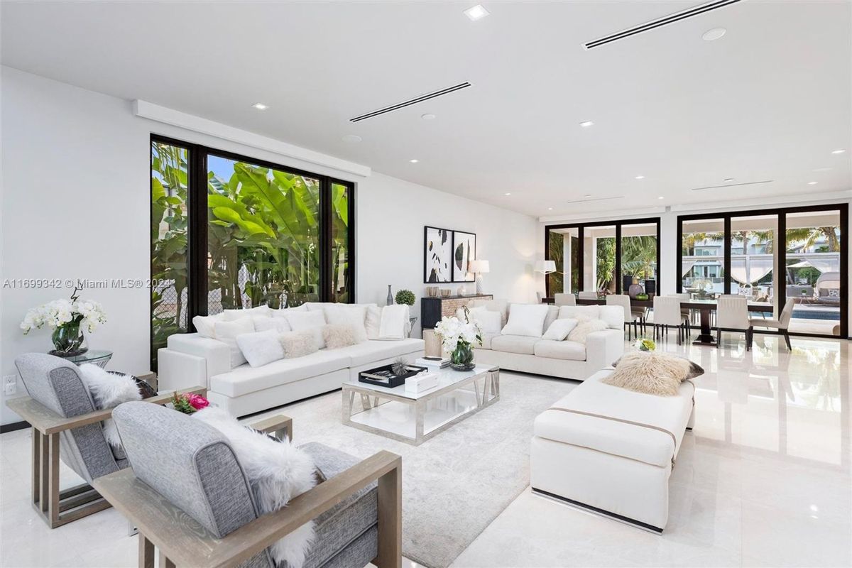 Open-concept living and dining area with sleek modern furniture.