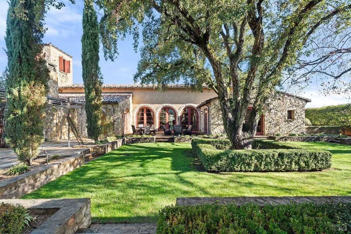 Charming stone architecture nestled within lush gardens creates a serene retreat.