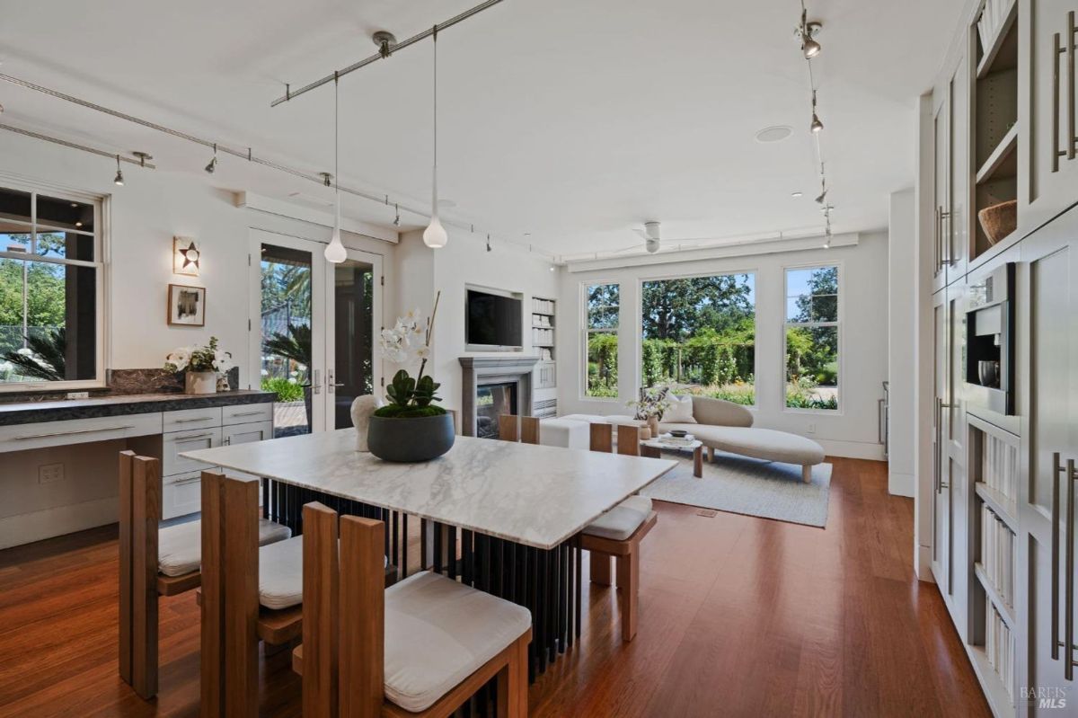 Bright dining area adjacent to a cozy sitting room with garden views.