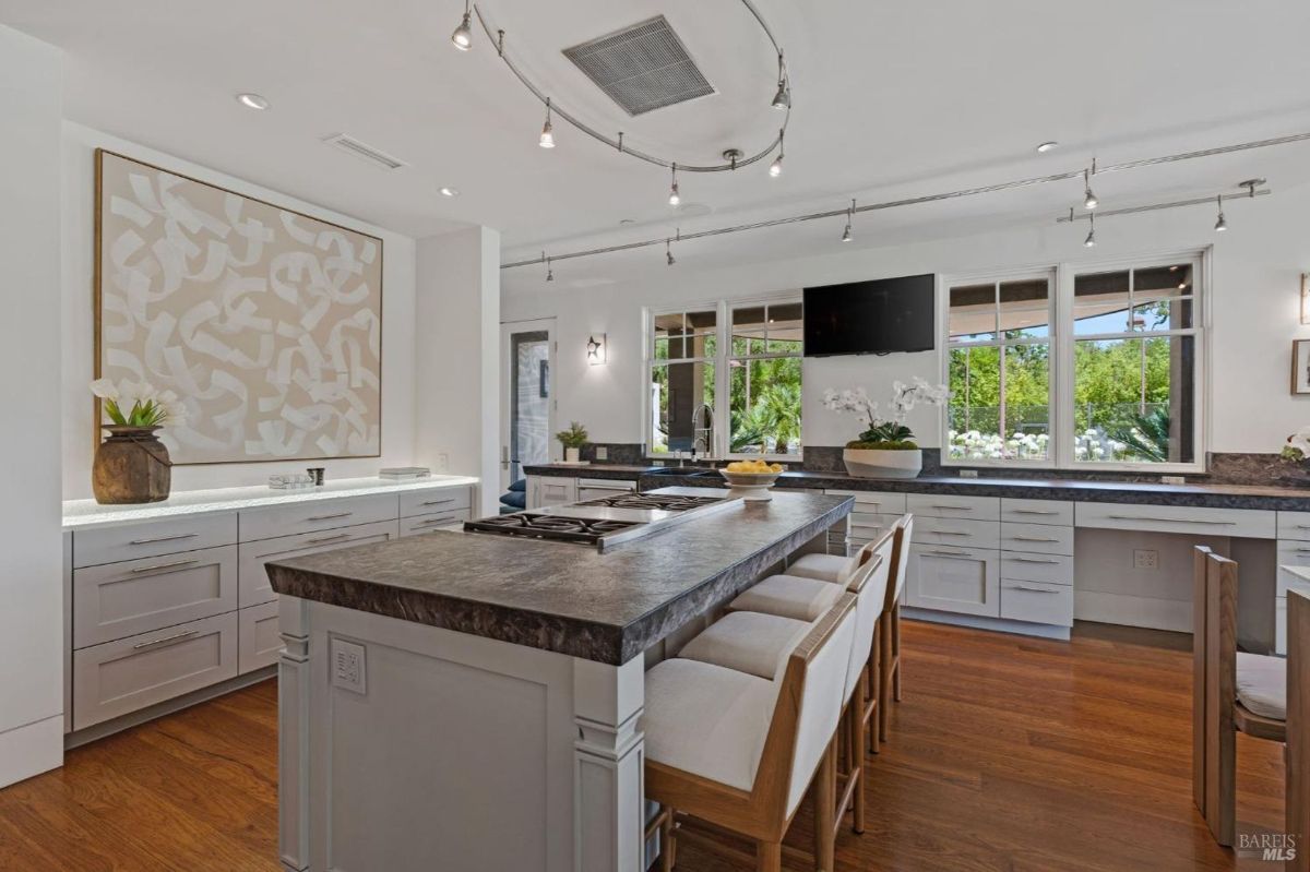 Elegant kitchen featuring a central island, custom cabinetry, and scenic views through large windows.