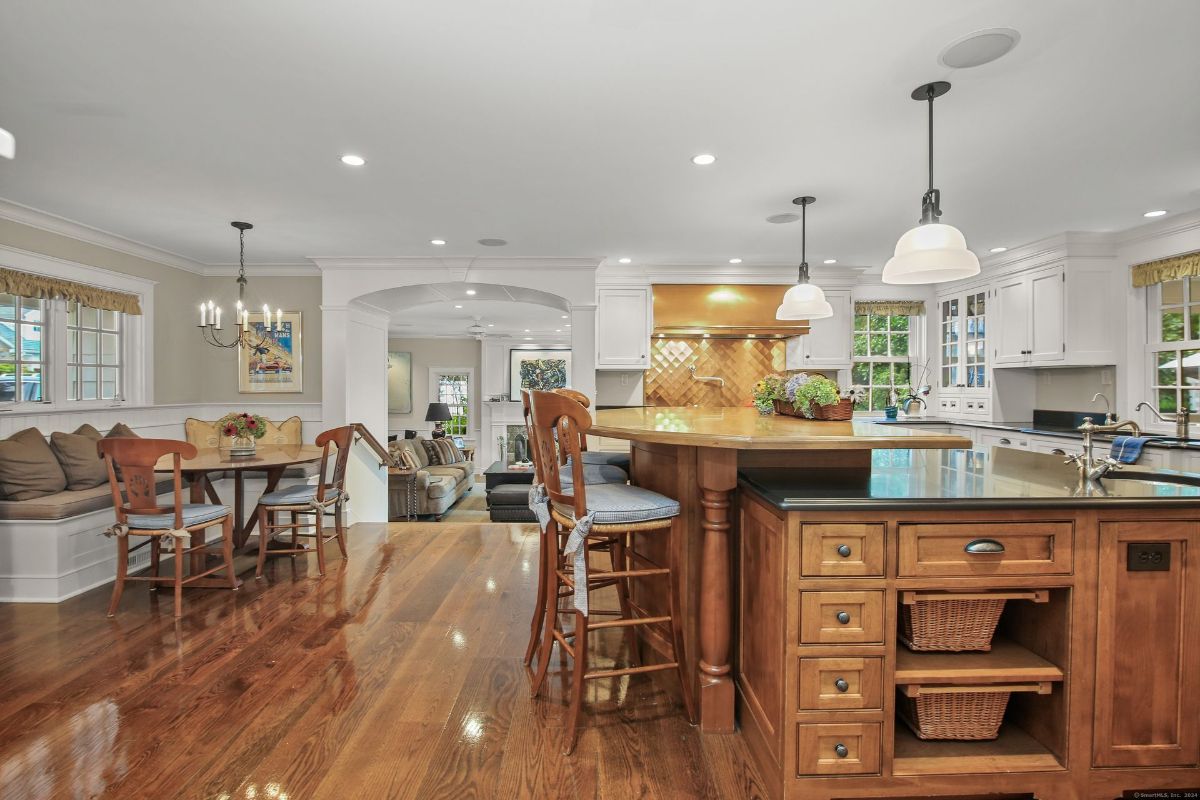 Open-concept kitchen with a custom island, integrated breakfast nook, and seamless flow into the adjacent living space.