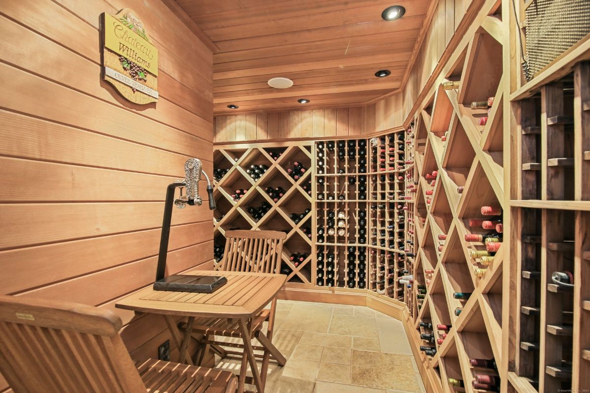 Elegant wine cellar with custom wooden racks, ambient lighting, and a tasting area for an immersive experience.