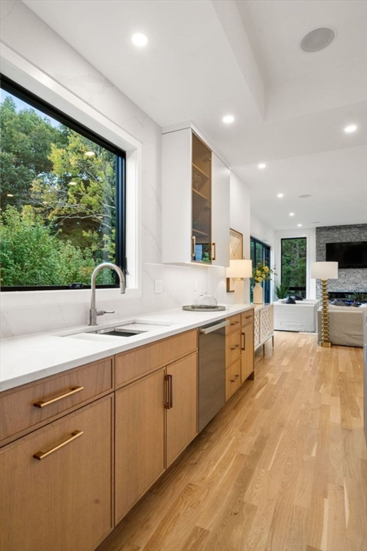 Bright and inviting kitchen space featuring large windows and sleek modern cabinetry.