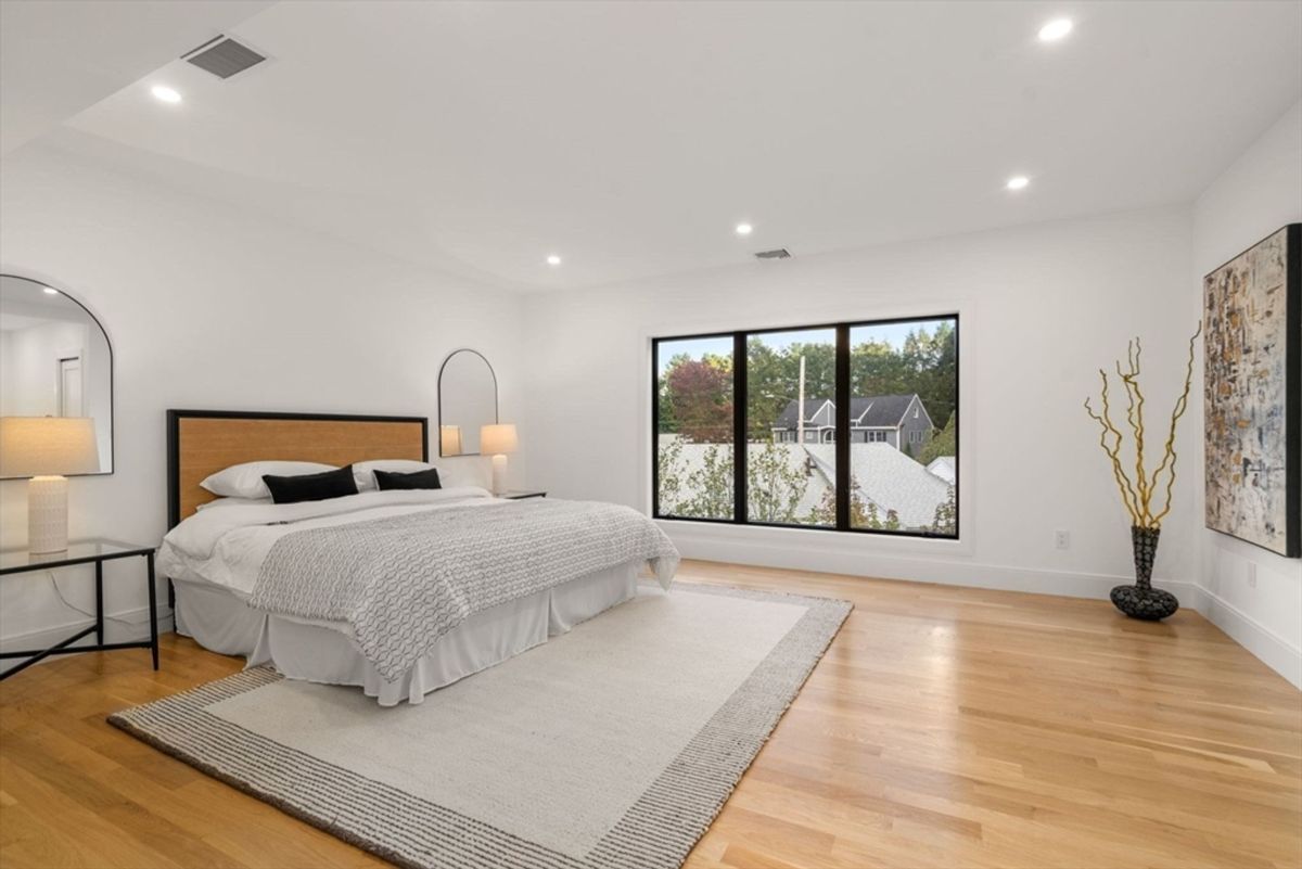 Primary bedroom featuring a minimalist design and large windows for natural light.