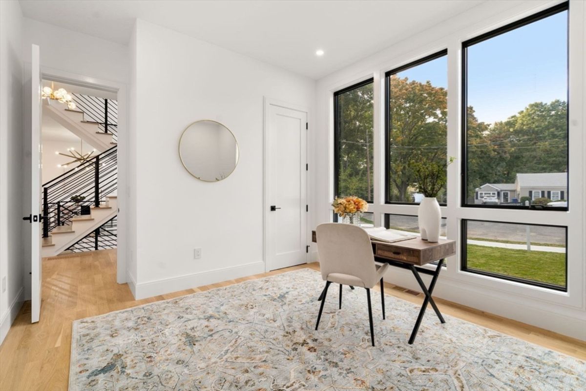 A cozy workspace bathed in natural light from oversized windows.