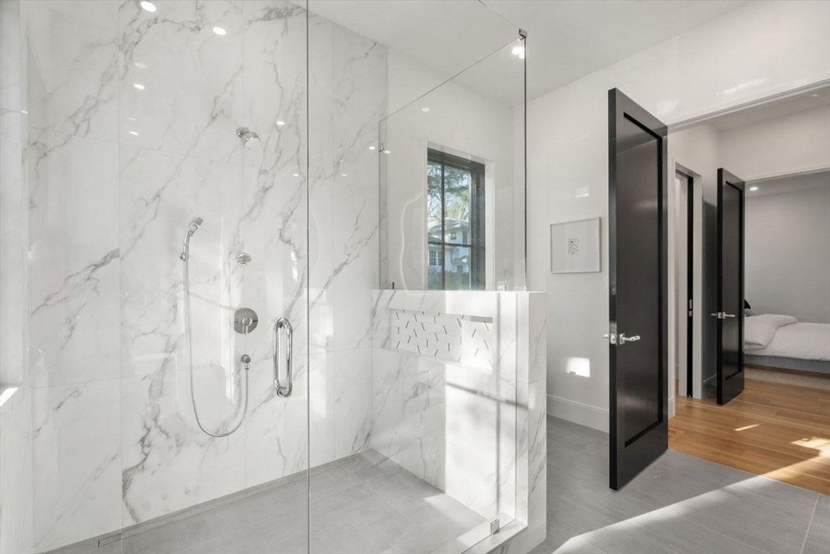 Frameless glass shower and freestanding tub add a spa-like ambiance to the bathroom.