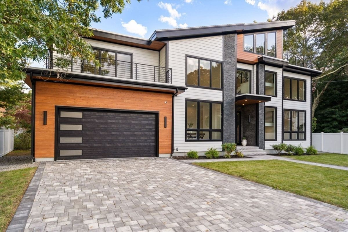 Driveway leads to a bold and elegant architectural design.